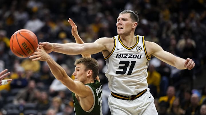 Nov 25, 2023; Columbia, Missouri, USA; Loyola (Md) Greyhounds guard Chris Kuzemka (20) and Missouri Tigers guard Caleb Grill (31) fight for a rebound during the second half at Mizzou Arena. Mandatory Credit: Jay Biggerstaff-Imagn Images
