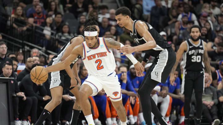 Mar 29, 2024; San Antonio, Texas, USA; New York Knicks guard Miles McBride (2) steals the ball away from San Antonio Spurs guard Devin Vassell (24) and forward Victor Wembanyama (1) during the second half at Frost Bank Center. Mandatory Credit: Scott Wachter-USA TODAY Sports