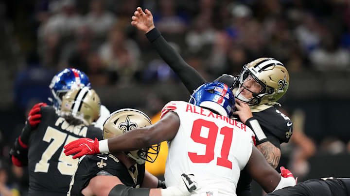 Oct 5, 2025; New Orleans, Louisiana, USA; New York Giants defensive tackle Darius Alexander (91) hits New Orleans Saints quarterback Spencer Rattler (2) as he passes the ball during the first quarter at Caesars Superdome. Oct 5, 2025; New Orleans, Louisiana, USA; New York Giants defensive tackle Darius Alexander (91) hits New Orleans Saints quarterback Spencer Rattler (2) as he passes the ball during the first quarter at Caesars Superdome.