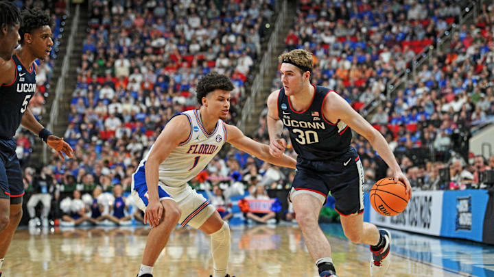 Mar 23, 2025; Raleigh, NC, USA; Connecticut Huskies forward Liam McNeeley (30) drives to the basket during the second half against Florida Gators guard Walter Clayton Jr. (1) in the second round of the NCAA Tournament at Lenovo Center. Mandatory Credit: Zachary Taft-Imagn Images Mar 23, 2025; Raleigh, NC, USA; Connecticut Huskies forward Liam McNeeley (30) drives to the basket during the second half against Florida Gators guard Walter Clayton Jr. (1) in the second round of the NCAA Tournament at Lenovo Center. Mandatory Credit: Zachary Taft-Imagn Images