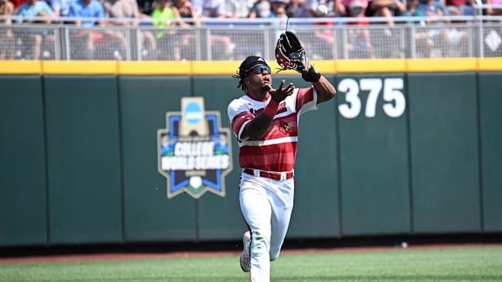 Jun 15, 2025; Omaha, Neb, USA;  Louisville Cardinals left fielder Zion Rose (32) makes an catch on the run against the Arizona Wildcats during the eighth inning at Charles Schwab Field. Mandatory Credit: Steven Branscombe-Imagn Images