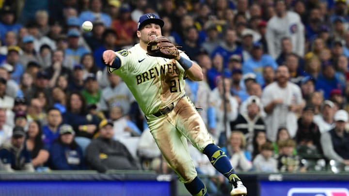 Oct 11, 2025; Milwaukee, Wisconsin, USA; Milwaukee Brewers third baseman Caleb Durbin (21) throws out Chicago Cubs third baseman Matt Shaw (6) in the third inning during game five of the NLDS round for the 2025 MLB playoffs at American Family Field. Mandatory Credit: Benny Sieu-Imagn Images