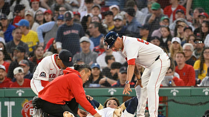 Boston Red Sox first baseman Triston Casas (36) is attended to by coaching and medical staff during the second inning against the Minnesota Twins at Fenway Park on May 2.