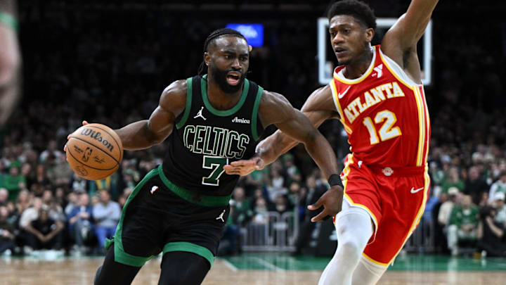Jan 18, 2025; Boston, Massachusetts, USA; Boston Celtics guard Jaylen Brown (7) drives to the basket against Atlanta Hawks forward De'Andre Hunter (12) during overtime at the TD Garden. Mandatory Credit: Brian Fluharty-Imagn Images