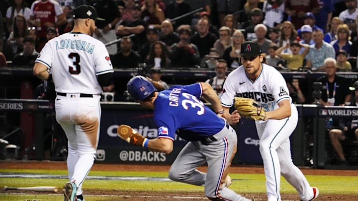 Arizona Diamondbacks relief pitcher Kevin Ginkel (37) tags out Texas Rangers center fielder Evan Carter (32) in a pickle during the seventh inning during game five of the 2023 World Series at Chase Field in Phoenix on Nov. 1, 2023.