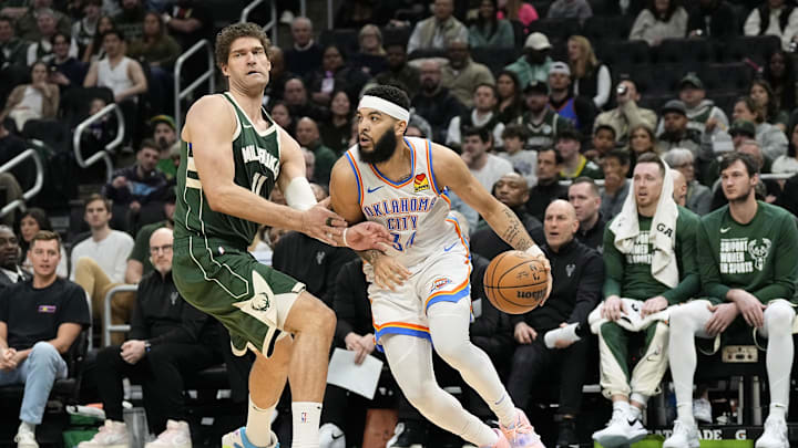 Mar 24, 2024; Milwaukee, Wisconsin, USA; Oklahoma City Thunder forward Kenrich Williams (34) drives towards the basket against Milwaukee Bucks center Brook Lopez (11) during the second quarter at Fiserv Forum. Mandatory Credit: Jeff Hanisch-USA TODAY Sports Mar 24, 2024; Milwaukee, Wisconsin, USA; Oklahoma City Thunder forward Kenrich Williams (34) drives towards the basket against Milwaukee Bucks center Brook Lopez (11) during the second quarter at Fiserv Forum. Mandatory Credit: Jeff Hanisch-USA TODAY Sports