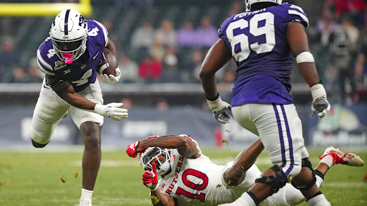 Kansas State running back Joe Jackson (4) jumps an attempted tackle from Rutgers cornerback Flip Dixon (10) during second half of the Rate Bowl at Chase Field on Dec. 26, 2024, in Phoenix.