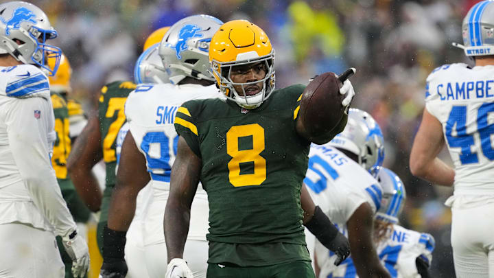 Green Bay Packers running back Josh Jacobs (8) gestures after earning a first down against the Detroit Lions.