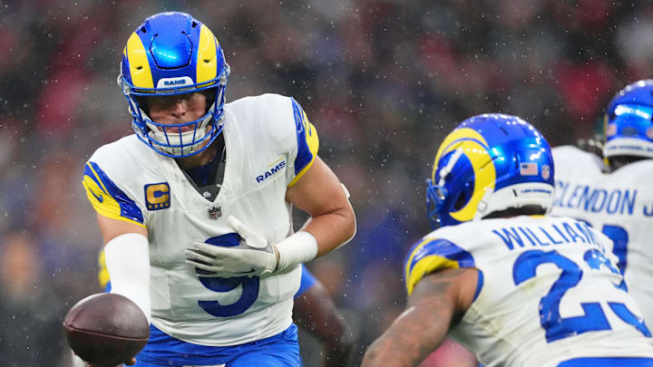 Oct 19, 2025; London, United Kingdom; Los Angeles Rams quarterback Matthew Stafford (9) hands the ball off to running back Kyren Williams (23) during the first half of an NFL International Series game at Wembley Stadium. Mandatory Credit: Kirby Lee-Imagn Images