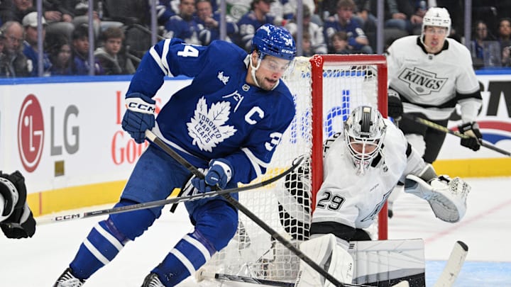 Oct 16, 2024; Toronto, Ontario, CAN; Toronto Maple Leafs forward Auston Matthews (34) brings the puck around the goal area of Los Angeles Kings goalie Phoenix Copley (29) in the third period at Scotiabank Arena. Mandatory Credit: Dan Hamilton-Imagn Images