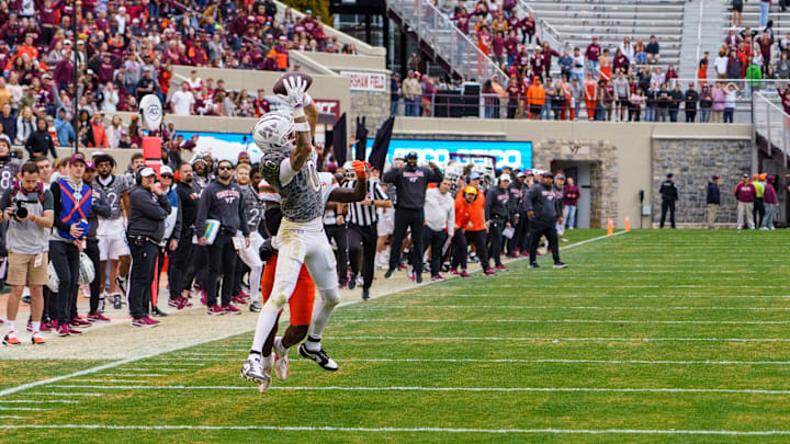 Nov 22, 2025; Blacksburg, Va.; Virginia Tech wide receiver Ayden Greene (0) catches the football for a first down against Miami defensive back Damari Brown (2).