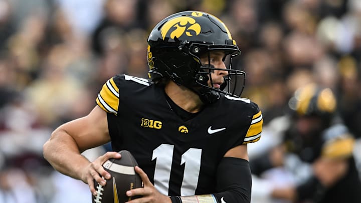 Oct 25, 2025; Iowa City, Iowa, USA; Iowa Hawkeyes quarterback Mark Gronowski (11) runs with the ball during the first quarter against the Minnesota Golden Gophers at Kinnick Stadium. Mandatory Credit: Jeffrey Becker-Imagn Images