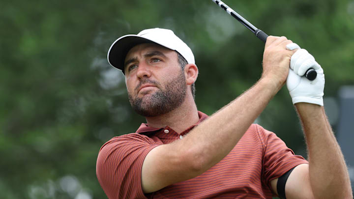 Scottie Scheffler plays his shot from the first tee during the third round of the U.S. Open golf tournament. 