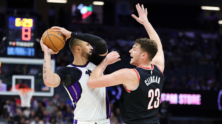 Oct 13, 2024; Sacramento, California, USA; Sacramento Kings center Alex Len (25) controls the ball against Portland Trail Blazers center Donovan Clingan (23) during the fourth quarter at Golden 1 Center. Mandatory Credit: Sergio Estrada-Imagn Images