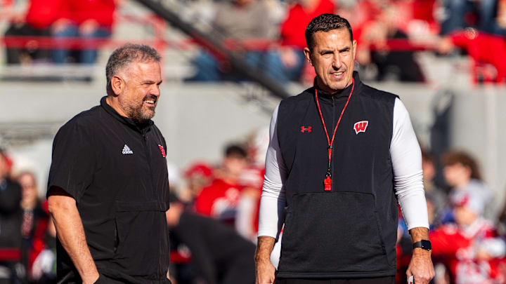 Nov 23, 2024; Lincoln, Nebraska, USA; Nebraska Cornhuskers head coach Matt Rhule and Wisconsin Badgers head coach Luke Fickell talk before a game at Memorial Stadium. Mandatory Credit: Dylan Widger-Imagn Images