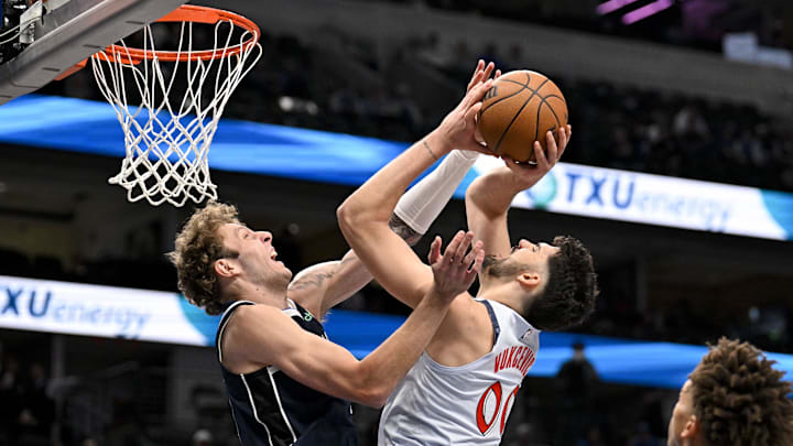 Jan 27, 2025; Dallas, Texas, USA; Washington Wizards forward Tristan Vukcevic (00) is fouled by Dallas Mavericks center Kylor Kelley (50) during the second half at the American Airlines Center. Mandatory Credit: Jerome Miron-Imagn Images
