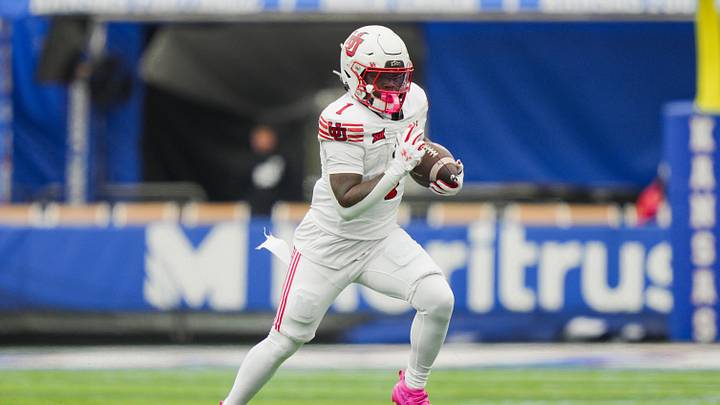 Nov 28, 2025; Lawrence, Kansas, USA; Utah Utes running back Wayshawn Parker (1) runs the ball during the second half against the Utah Utes at David Booth Kansas Memorial Stadium. Mandatory Credit: Jay Biggerstaff-Imagn Images