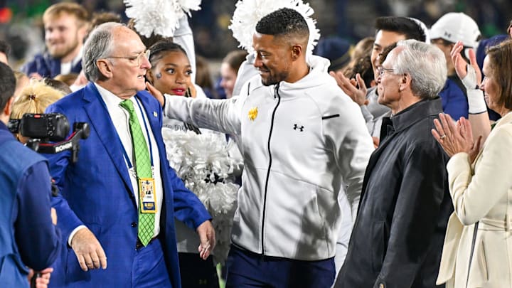 Nov 18, 2023; South Bend, Indiana, USA; Notre Dame Fighting Irish head coach Marcus Freeman, center, celebrates with Notre Dame Athletic Director Jack Swarbrick, left, and Notre Dame President Rev. John I. Jenkins, C.S.C. following the win over the Wake Forest Demon Deacons at Notre Dame Stadium. Both Swarbrick and Jenkins announced they will step down from their jobs in the coming months and it was the final home football game for both. Mandatory Credit: Matt Cashore-Imagn Images Nov 18, 2023; South Bend, Indiana, USA; Notre Dame Fighting Irish head coach Marcus Freeman, center, celebrates with Notre Dame Athletic Director Jack Swarbrick, left, and Notre Dame President Rev. John I. Jenkins, C.S.C. following the win over the Wake Forest Demon Deacons at Notre Dame Stadium. Both Swarbrick and Jenkins announced they will step down from their jobs in the coming months and it was the final home football game for both. Mandatory Credit: Matt Cashore-Imagn Images