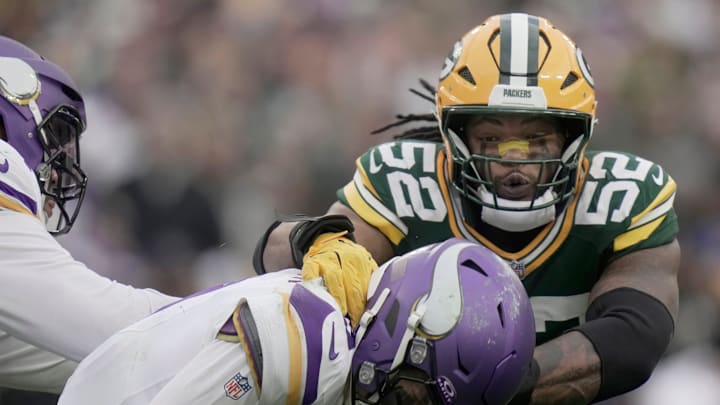 Minnesota Vikings' J.J. McCarthy (9) evades a sack by Green Bay Packers defensive end Rashan Gary (52) during the fourth quarter of their game Sunday, November 23, 2025 at Lambeau Field in Green Bay, Wisconsin. The Green Bay Packers beat the Minnesota Vikings 23-6.