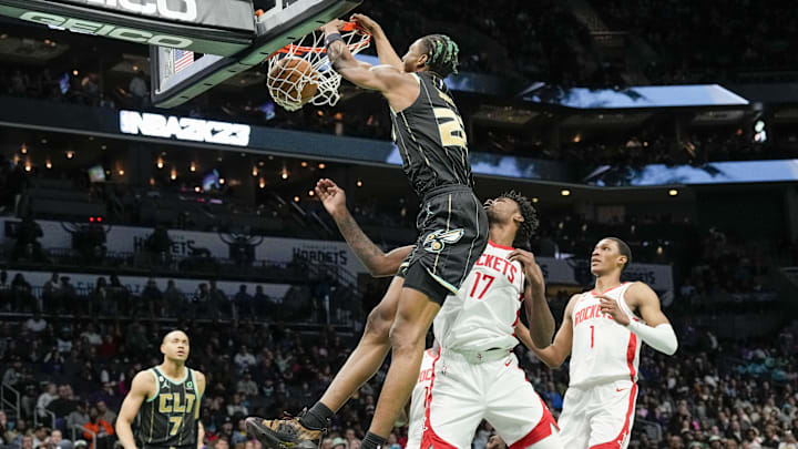 Apr 7, 2023; Charlotte, North Carolina, USA; Charlotte Hornets forward Kai Jones (23) dunks  over Houston Rockets forward Tari Eason (17) during the second half at the Spectrum Center. Mandatory Credit: Jim Dedmon-Imagn Images
