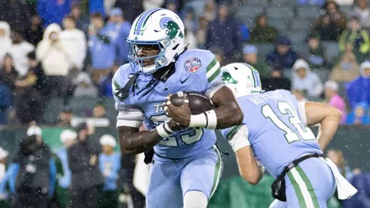 Dec 05, 2026; New Orleans, LA, USA; Tulane running back Jamauri McClure (25) takes a handoff from former TU quarterback, Jake Retzlaff (12) during the American Conference Championship against North Texas at Yulman Stadium. Mandatory Credit: Tulane Athletics Dec 05, 2026; New Orleans, LA, USA; Tulane running back Jamauri McClure (25) takes a handoff from former TU quarterback, Jake Retzlaff (12) during the American Conference Championship against North Texas at Yulman Stadium. Mandatory Credit: Tulane Athletics