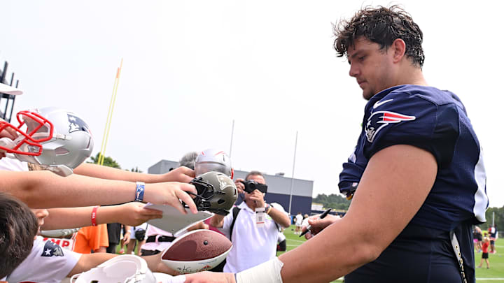 Aug 6, 2025; Foxborough, MA, USA; New England Patriots offensive tackle Will Campbell signs autographs after training camp at Gillette Stadium