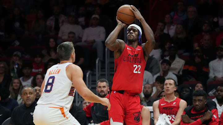 Dec 7, 2024; Miami, Florida, USA;  Miami Heat forward Jimmy Butler (22) shoots the ball against Phoenix Suns guard Grayson Allen (8) during the second half at Kaseya Center. Mandatory Credit: Jim Rassol-Imagn Images