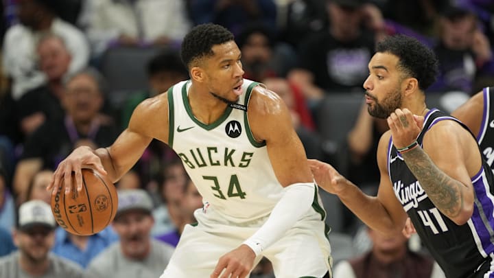 Mar 22, 2025; Sacramento, California, USA; Milwaukee Bucks forward Giannis Antetokounmpo (34) dribbles against Sacramento Kings forward Trey Lyles (41) during the third quarter at Golden 1 Center. Mandatory Credit: Darren Yamashita-Imagn Images
