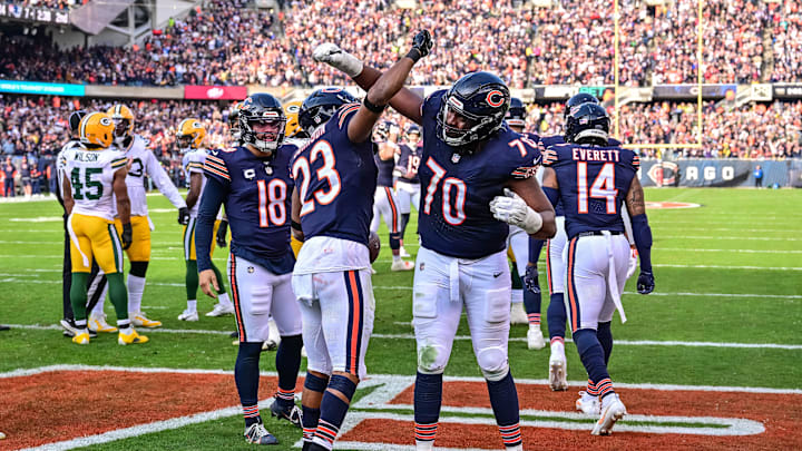 Nov 17, 2024; Chicago, Illinois, USA; Chicago Bears running back Roschon Johnson (23) celebrates his rushing touchdown with offensive tackle Braxton Jones (70) against the Green Bay Packers during the second quarter at Soldier Field. Mandatory Credit: Daniel Bartel-Imagn Images