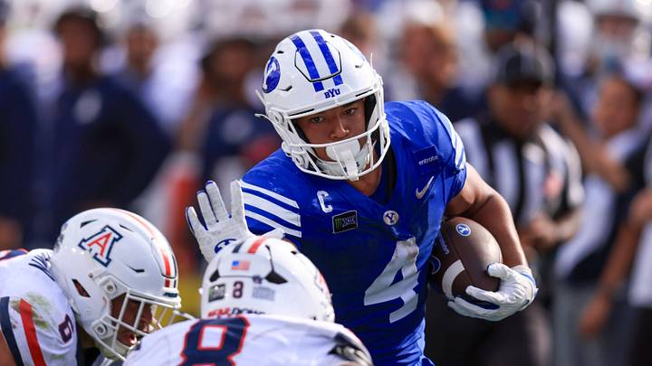 Sep 12, 2026; Provo, Utah, USA;  BYU Cougars running back Lj Martin (4) runs the ball against the Arizona Wildcats during the second half at LaVell Edwards Stadium.  Mandatory Credit: Rob Gray-Imagn Images