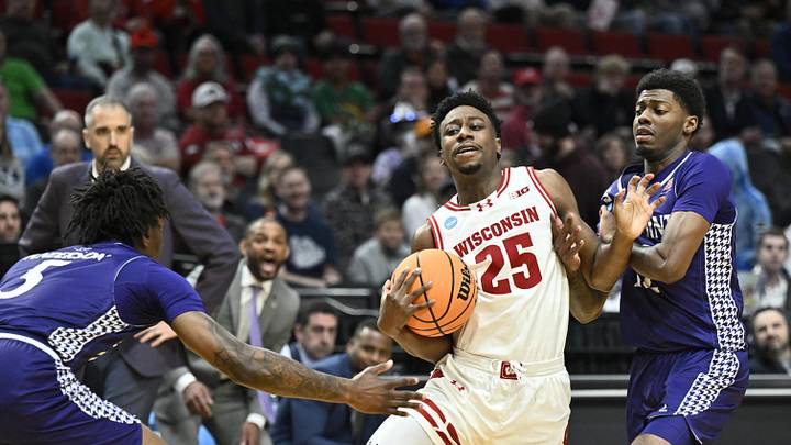 Mar 19, 2026; Portland, OR, USA; Wisconsin Badgers guard John Blackwell (25) controls the ball against High Point Panthers forward Terry Anderson (5) during the first half of a first round game of the men's 2026 NCAA Tournament at Moda Center. Mandatory Credit: Craig Strobeck-Imagn Images