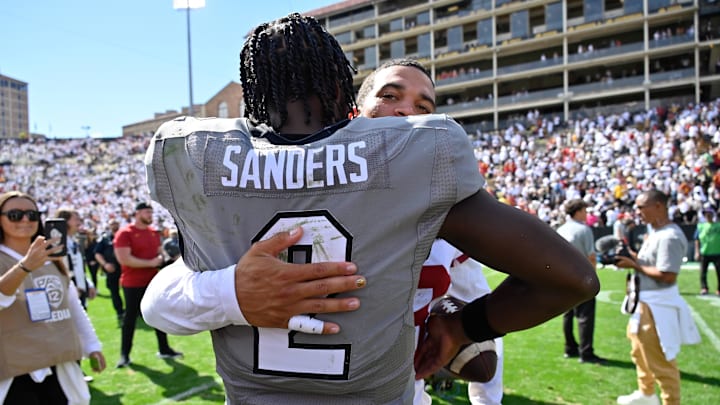 Sep 30, 2023; Boulder, Colorado, USA;  Colorado Buffaloes quarterback Shedeur Sanders (2) gets a hug