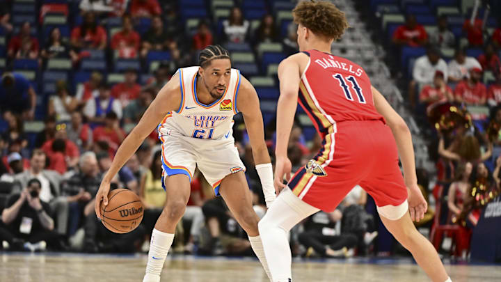 Apr 27, 2024; New Orleans, Louisiana, USA; Oklahoma City Thunder Guard Aaron Wiggins (21) handles the ball while defended by New Orleans Pelicans Guard Dyson Daniels (11) during the fourth quarter of game three of the first round for the 2024 NBA playoffs at Smoothie King Center. Mandatory Credit: Matt Bush-Imagn Images