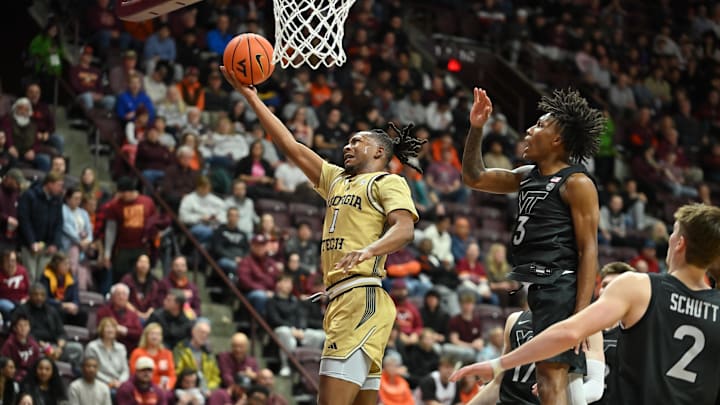 Jan 27, 2026; Blacksburg, Virginia, USA;  Georgia Tech Yellow Jackets guard Lamar Washington (1) lays the ball up defended by Virginia Tech Hokies guard Ben Hammond (3) at Cassell Coliseum. Mandatory Credit: Brian Bishop-Imagn Images