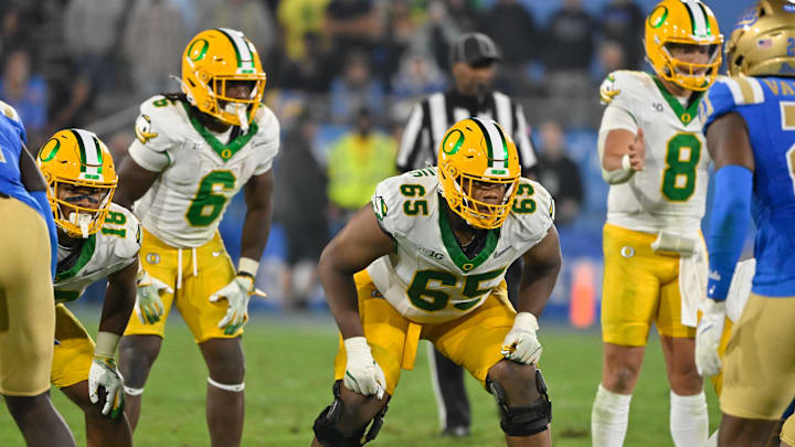 Sep 28, 2024; Pasadena, California, USA; Oregon Ducks offensive lineman Ajani Cornelius (65) during the third quarter against the UCLA Bruins at the Rose Bowl. Mandatory Credit: Robert Hanashiro-Imagn Images