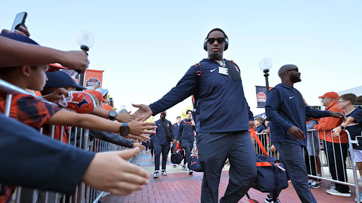 Sep 27, 2025; Champaign, Illinois, USA;  Members of the Illinois fighting Illini team take the Illini Walk greeting fans  before an NCAA football game with the Southern California Trojans at Memorial Stadium. Mandatory Credit: Ron Johnson-Imagn Images