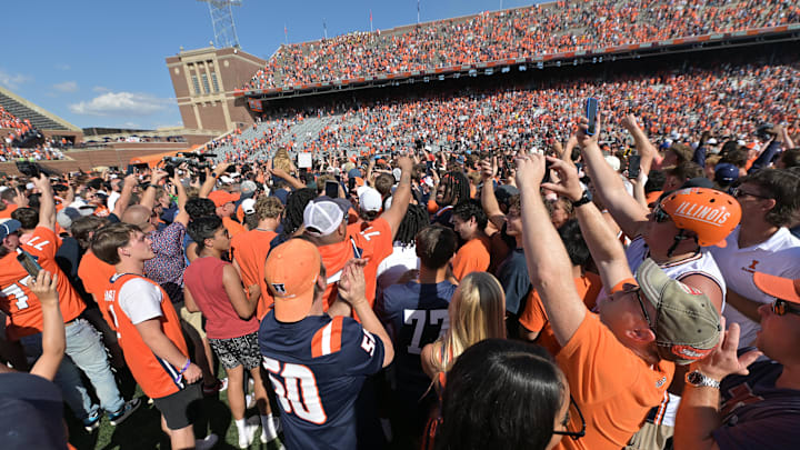 Sep 27, 2025; Champaign, Illinois, USA;  Fans flood the field after a 34-32 Illinois fighting Illini win over the Southern California Trojans at Memorial Stadium. Mandatory Credit: Ron Johnson-Imagn Images 