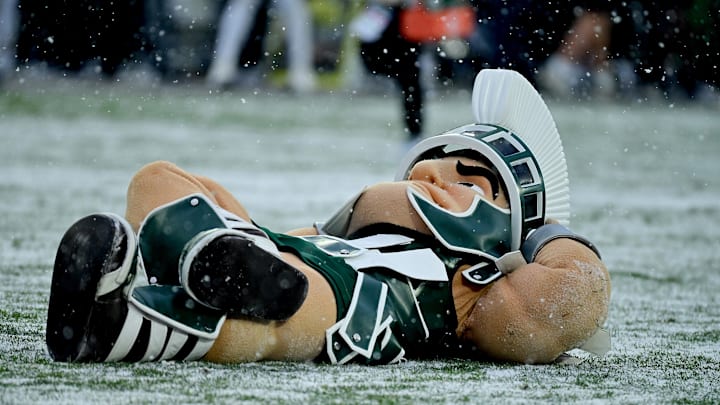 Nov 30, 2024; East Lansing, Michigan, USA;  Michigan State Spartans mascot Sparty relaxes at midfield during a game against the Rutgers Scarlet Knights at Spartan Stadium. Mandatory Credit: Dale Young-Imagn Images