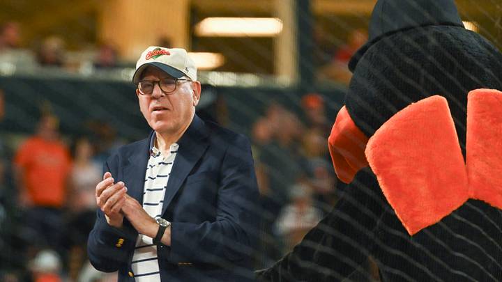 Jun 28, 2024; Baltimore, Maryland, USA;  Baltimore Orioles owner David Rubenstein  stands with Bird on top of the dugout during the seventh inning stretch against the Texas Rangers at Oriole Park at Camden Yards. Mandatory Credit: Tommy Gilligan-USA TODAY Sports