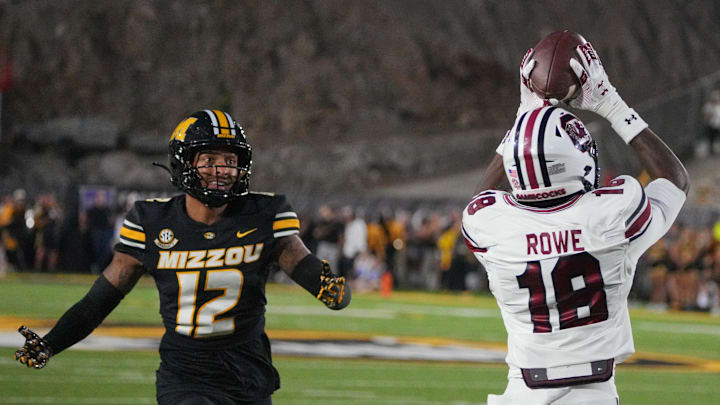 Sep 20, 2025; Columbia, Missouri, USA; South Carolina Gamecocks wide receiver Brian Rowe Jr. (18) catches a pass for a touchdown as Missouri Tigers cornerback Drey Norwood (12) looks on during the first half of the game at Faurot Field at Memorial Stadium. Mandatory Credit: Denny Medley-Imagn Images