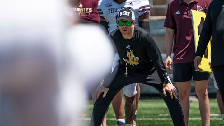 Texas State football Head coach GJ Kinne watches players closely during the Texas State football spring game at Bobcat Stadium.