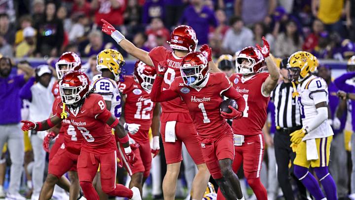 Dec 27, 2025; Houston, TX, USA; Houston Cougars defensive back Latrell McCutchin Sr. (1) recovers the onside kick during the second half against the Louisiana State Tigers at NRG Stadium. Mandatory Credit: Maria Lysaker-Imagn Images 