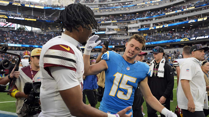 Commanders quarterback Jayden Daniels (5) and Chargers receiver Ladd McConkey (15) meet after Sunday's game.