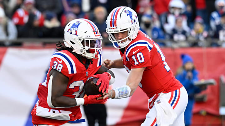 Dec 1, 2024; Foxborough, Massachusetts, USA; New England Patriots quarterback Drake Maye (10) hands the ball to running back Rhamondre Stevenson (38) during the second half at Gillette Stadium. Mandatory Credit: Eric Canha-Imagn Images Dec 1, 2024; Foxborough, Massachusetts, USA; New England Patriots quarterback Drake Maye (10) hands the ball to running back Rhamondre Stevenson (38) during the second half at Gillette Stadium. Mandatory Credit: Eric Canha-Imagn Images
