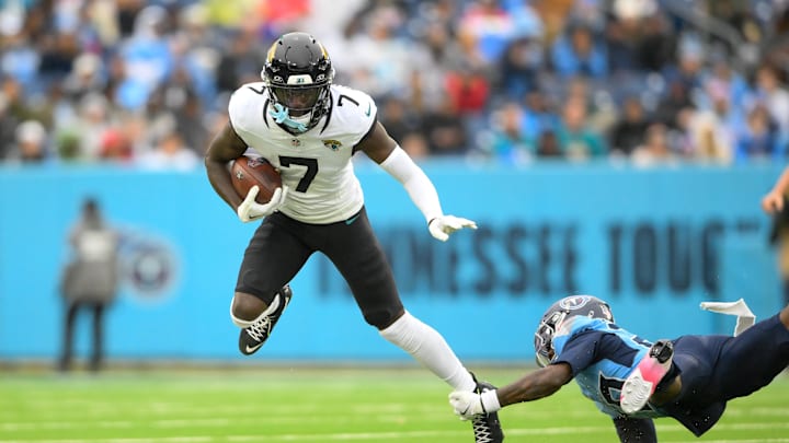 Dec 8, 2024; Nashville, Tennessee, USA;  Tennessee Titans cornerback Jarvis Brownlee Jr. (29) tackles Jacksonville Jaguars wide receiver Brian Thomas Jr. (7) during the first half at Nissan Stadium.