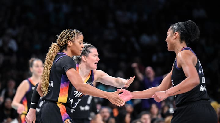 Jun 19, 2025; Brooklyn, New York, USA; Phoenix Mercury guard Monique Akoa Makani (8) slaps hands with guard Sami Whitcomb (33) and forward Alyssa Thomas (25) during the second half against the New York Liberty at Barclays Center. Mandatory Credit: John Jones-Imagn Images