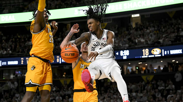 Mar 1, 2025; Nashville, Tennessee, USA;  Vanderbilt Commodores guard Jason Edwards (1) passes the ball as Missouri Tigers guard Jacob Crews (35) defends during the first half at Memorial Gymnasium. Mandatory Credit: Steve Roberts-Imagn Images