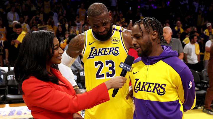 Oct 22, 2024; Los Angeles, California, USA; NBA on TNT sideline reporter Taylor Rooks interviews Los Angeles Lakers forward LeBron James (23) and guard Bronny James (9) after they defeated the Minnesota Timberwolves at Crypto.com Arena. Mandatory Credit: Jason Parkhurst-Imagn Images Oct 22, 2024; Los Angeles, California, USA; NBA on TNT sideline reporter Taylor Rooks interviews Los Angeles Lakers forward LeBron James (23) and guard Bronny James (9) after they defeated the Minnesota Timberwolves at Crypto.com Arena. Mandatory Credit: Jason Parkhurst-Imagn Images