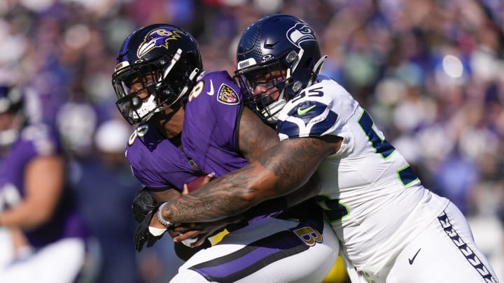 Nov 5, 2023; Baltimore, Maryland, USA;  Seattle Seahawks defensive end Dre'Mont Jones (55) sacks Baltimore Ravens quarterback Lamar Jackson (8) during the first half at M&T Bank Stadium. Mandatory Credit: Jessica Rapfogel-USA TODAY Sports
