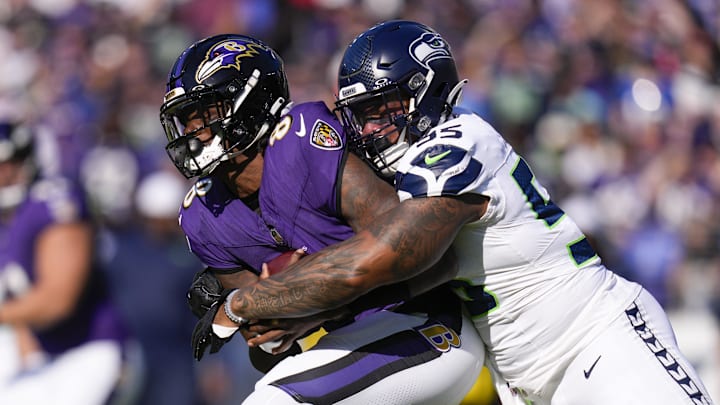 Nov 5, 2023; Baltimore, Maryland, USA;  Seattle Seahawks defensive end Dre'Mont Jones (55) sacks Baltimore Ravens quarterback Lamar Jackson (8) during the first half at M&T Bank Stadium. Mandatory Credit: Jessica Rapfogel-Imagn Images